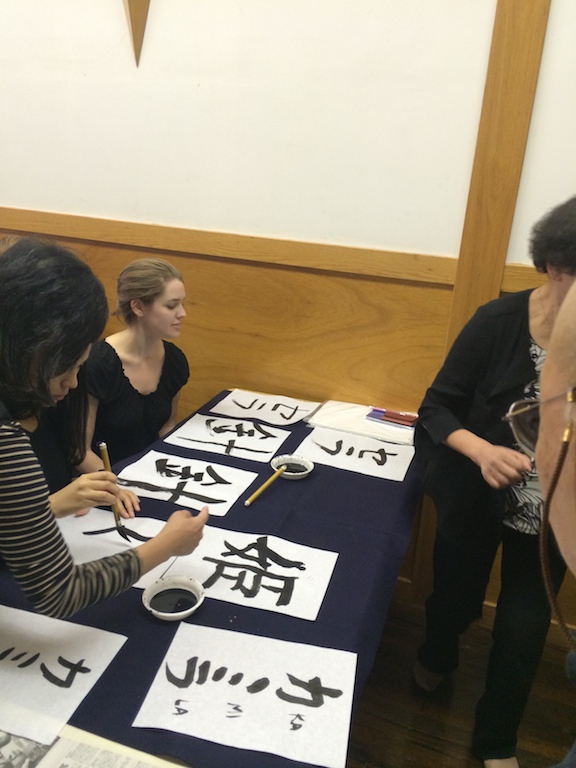 Student looks at her shodo (japanese calligraphy) work during the workshop at the Japanese Culture Center in Chicago.
